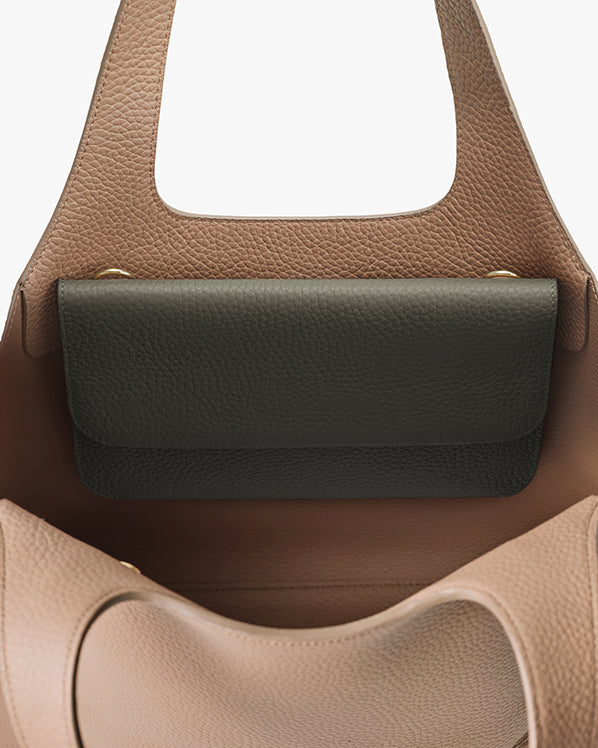 Open handbag showing an interior pocket.