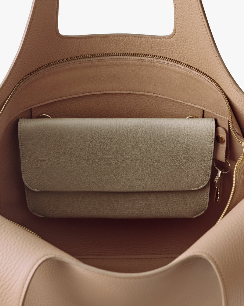 Open travel bag with a smaller bag inside.