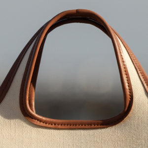Close-up of a textured bag handle and opening.
