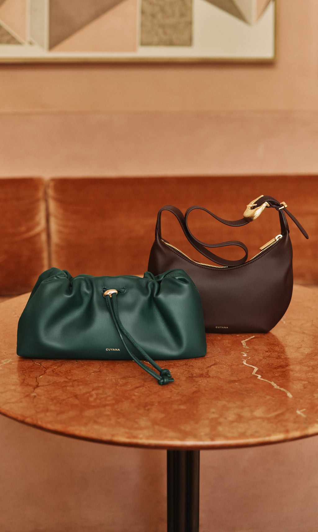 Two handbags on a round table indoors.