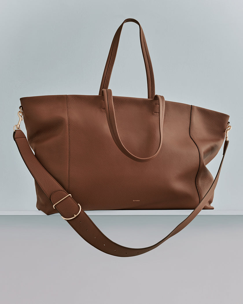 Large tote bag with long handles and an adjustable shoulder strap