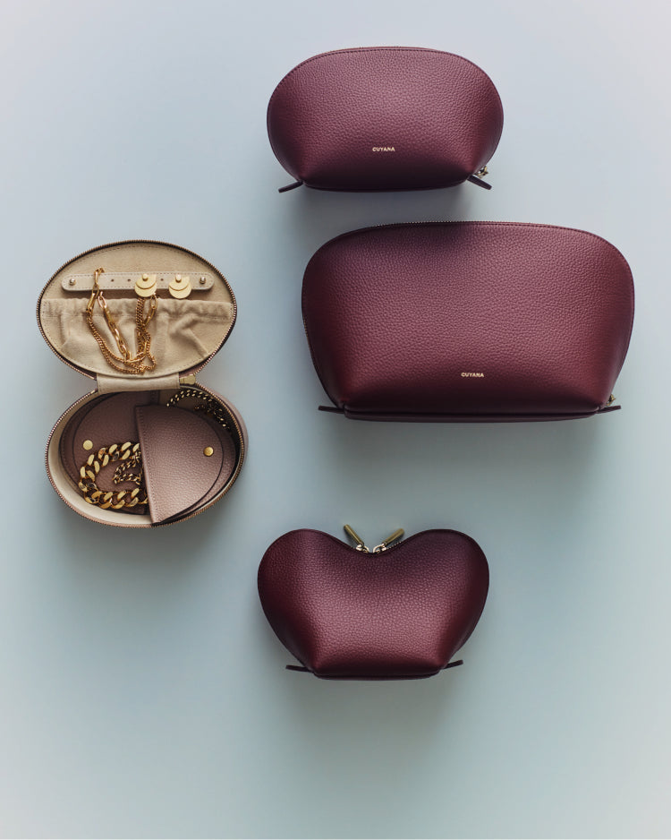 Five pouches, one open showing jewelry inside, arranged on a plain surface.