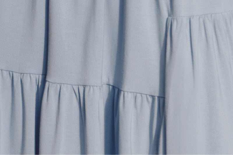 Close-up view of a garment with tiered ruffled design.