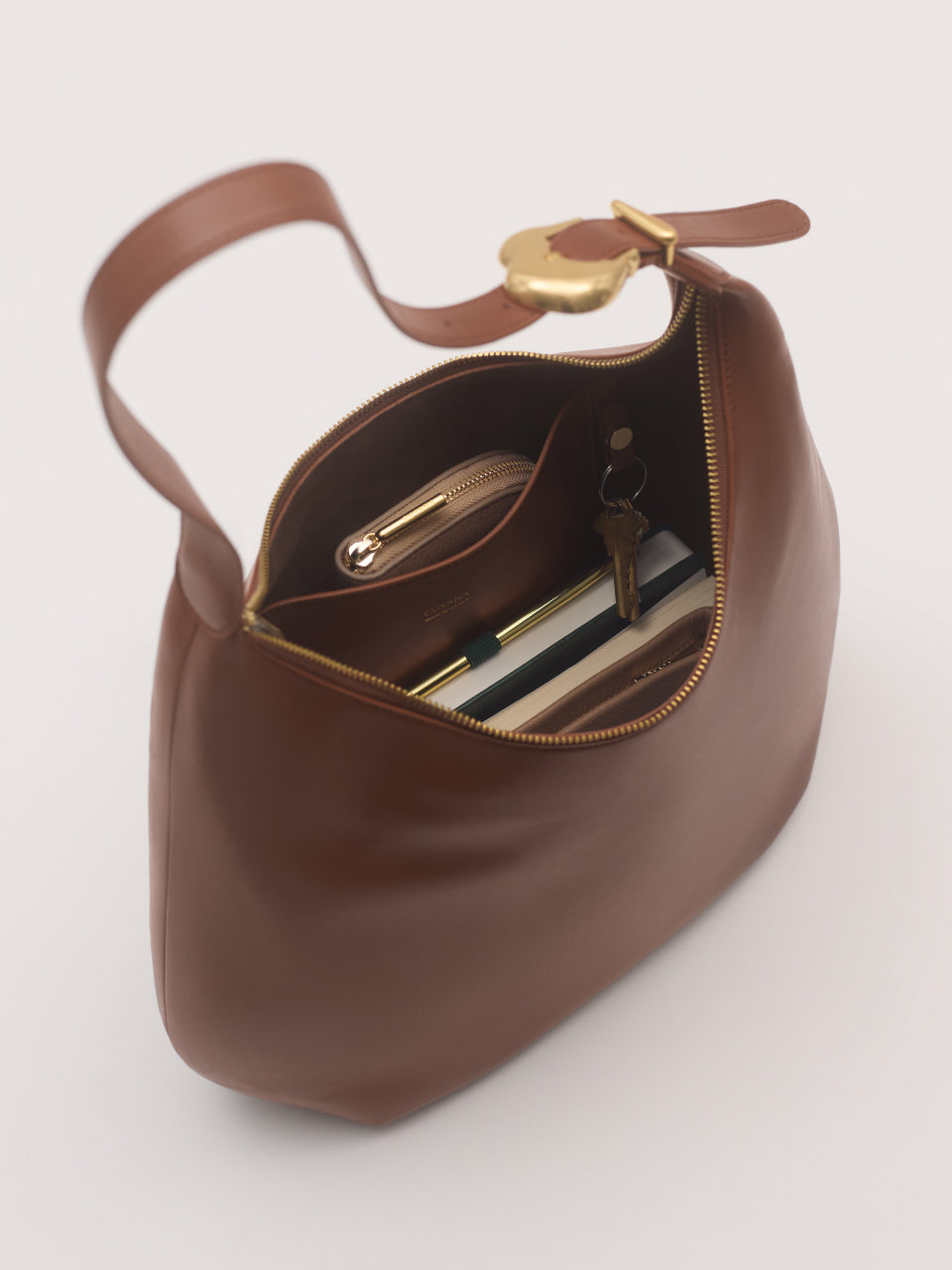 Open handbag with visible items inside like a wallet and keys