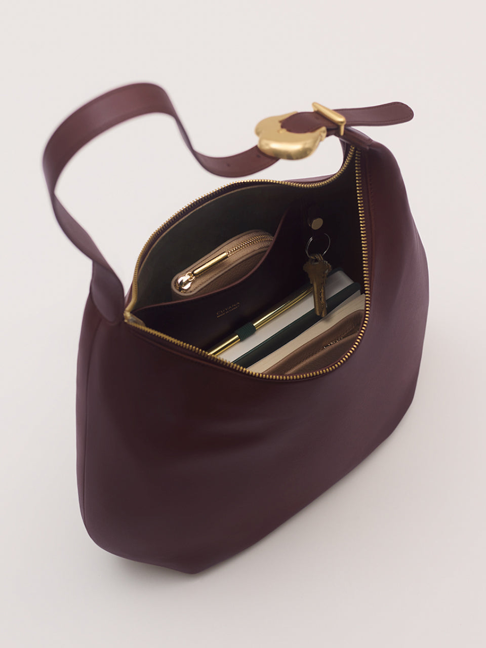 Open handbag with zipper revealing contents inside