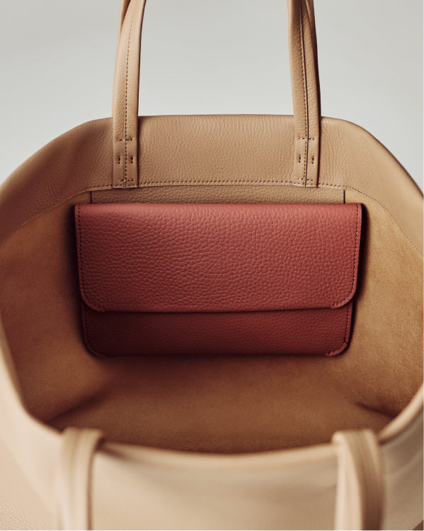 Open handbag with a small pouch inside.