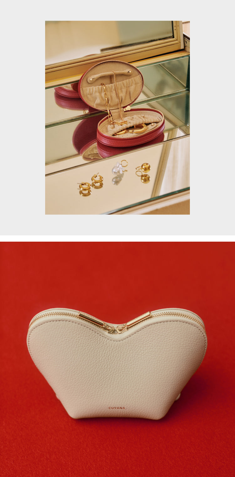 Jewelry holder with rings on shelf; heart-shaped pouch on red surface.