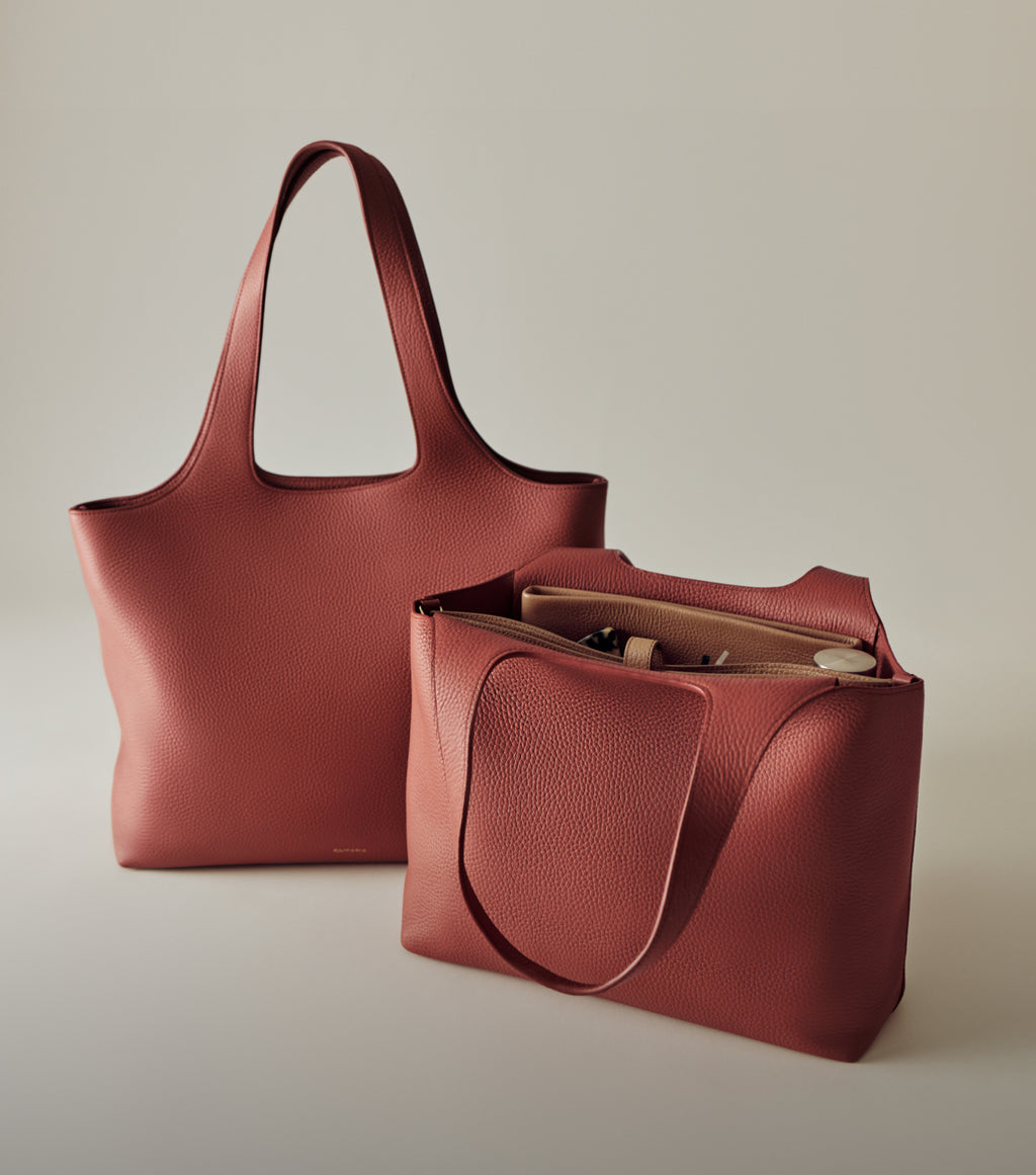 Two large tote bags with long handles, one open showing contents inside.