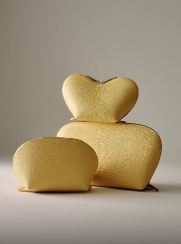 Three different sized textured pouches displayed against a neutral background.