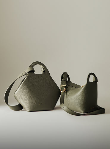 Two stylish handbags with unique shapes displayed side by side.