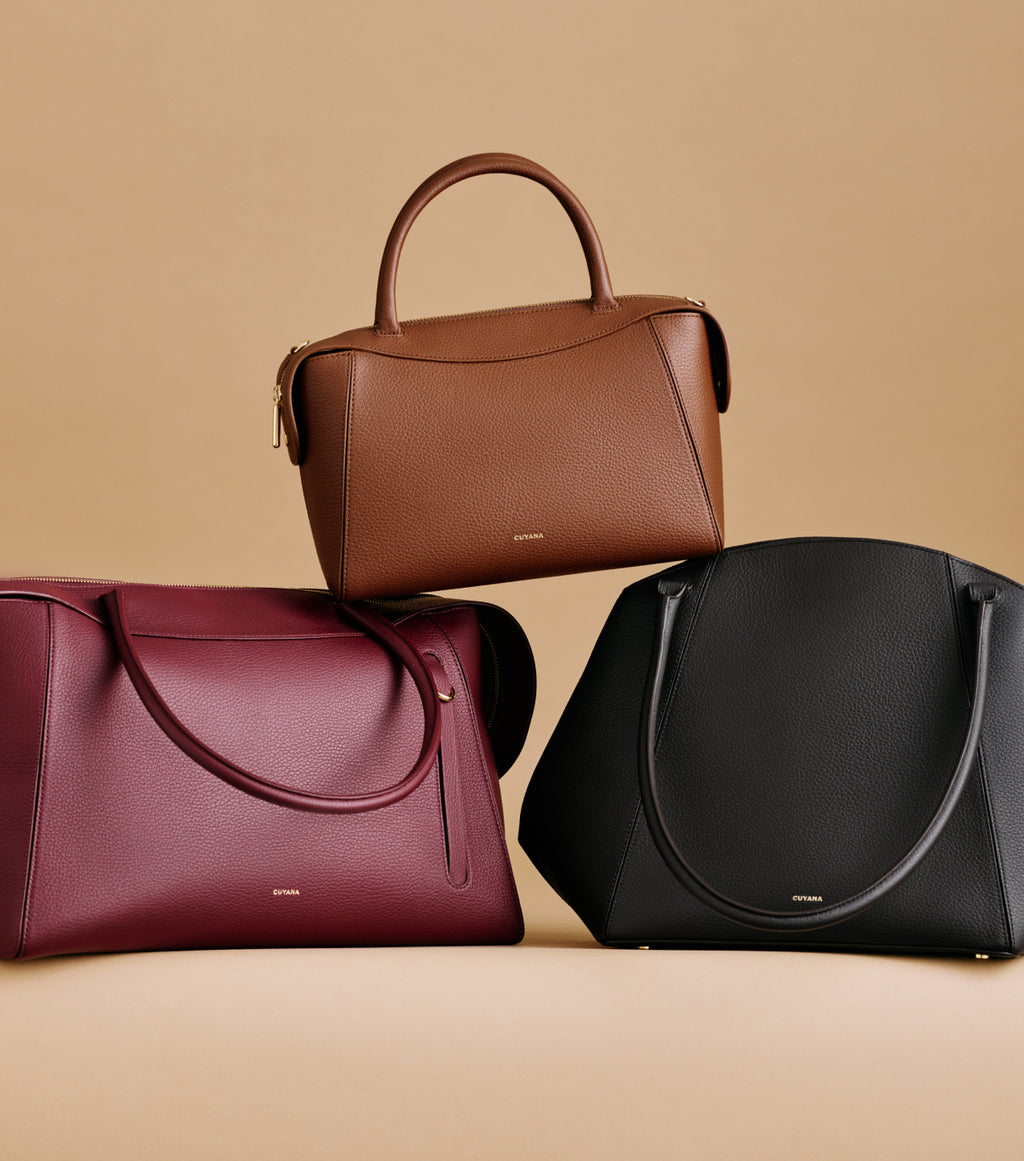 Three handbags arranged on a neutral background.