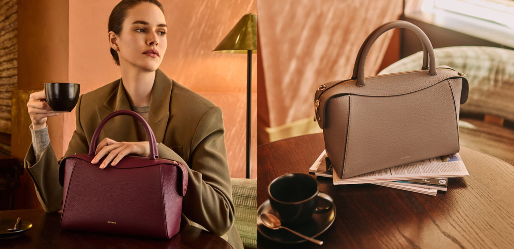 Person sitting with cup next to handbag; another handbag on table with books and cup nearby.