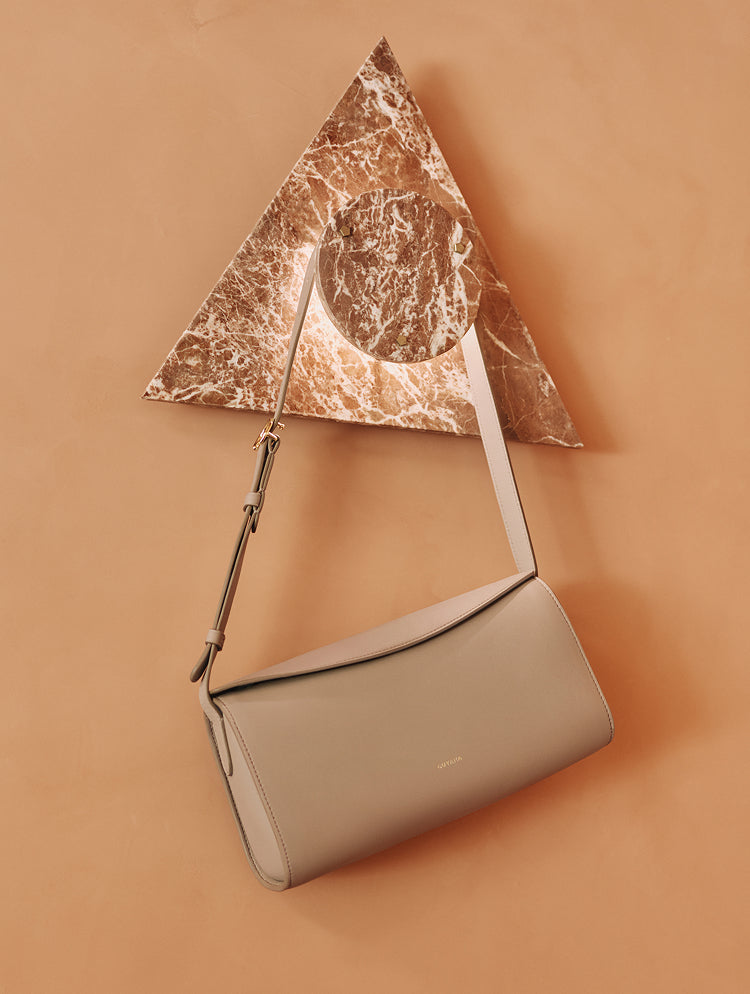 Shoulder bag hanging on triangular marble piece