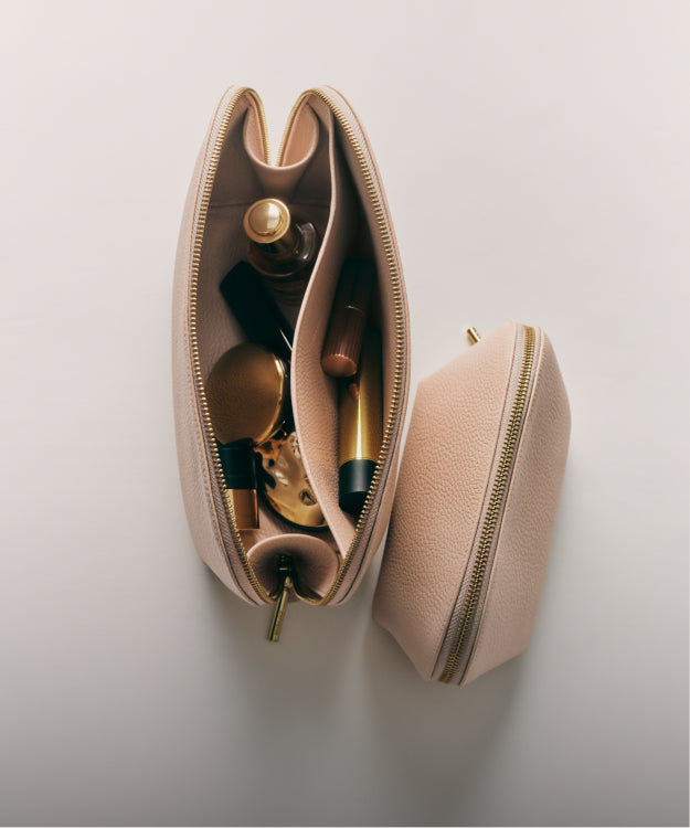 Open makeup bag with various cosmetics inside.