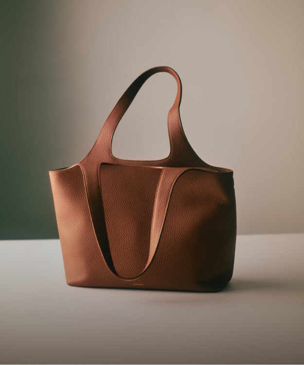 Tote bag with two handles placed on a flat surface