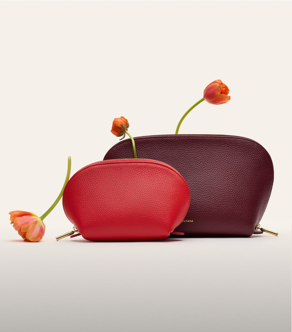 Two zip pouches with tulips placed against them.
