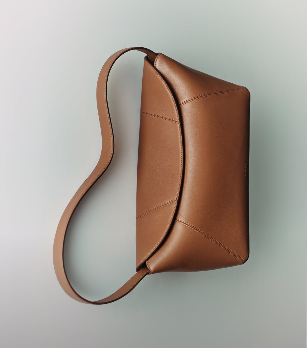 Shoulder bag with a curved design and single strap.