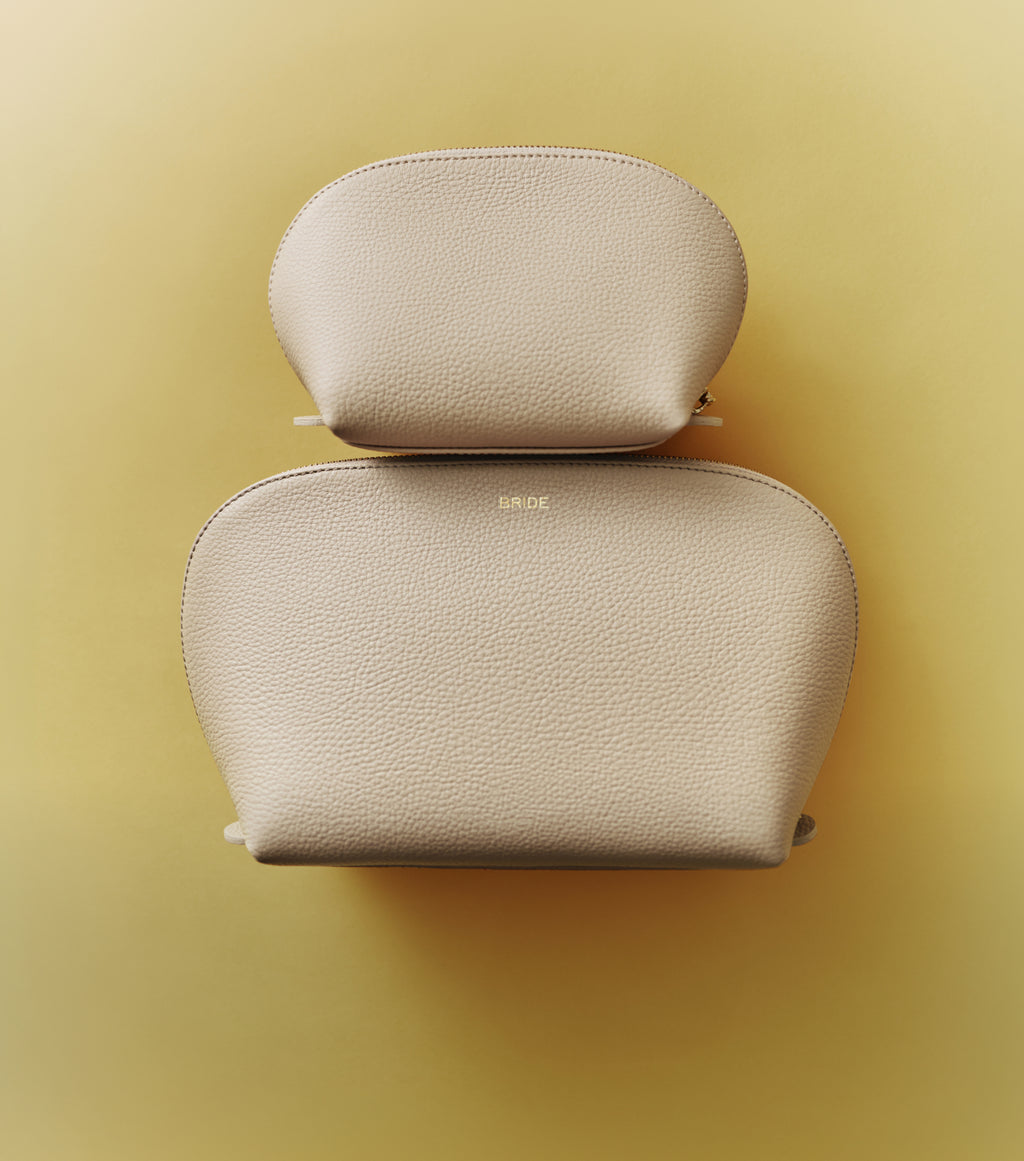 Two textured pouches, one smaller on top of a larger one, viewed from above.