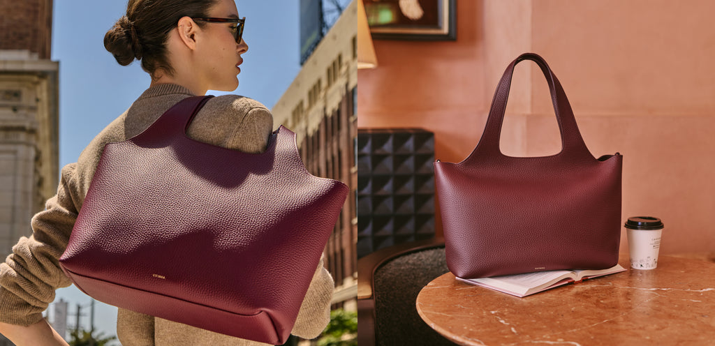 Person carrying large handbag with similar one on table nearby.