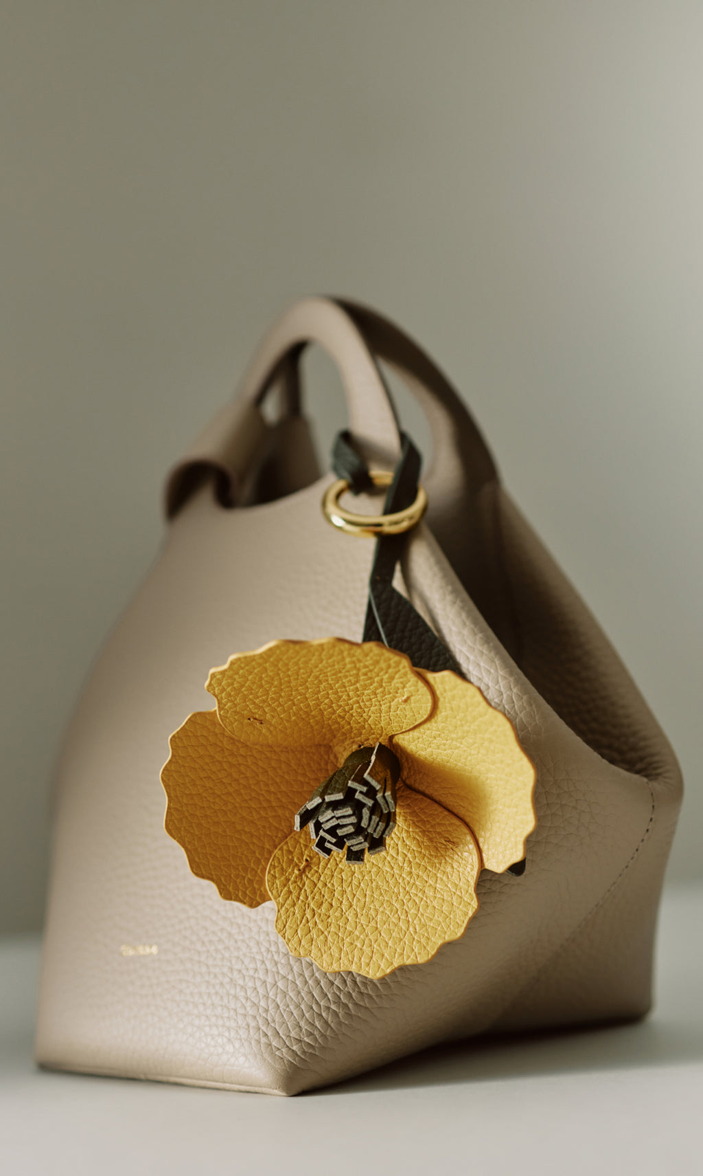 Handbag with large floral decoration attached