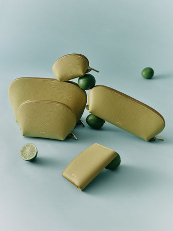Five pouches of varying sizes with limes on a flat surface.
