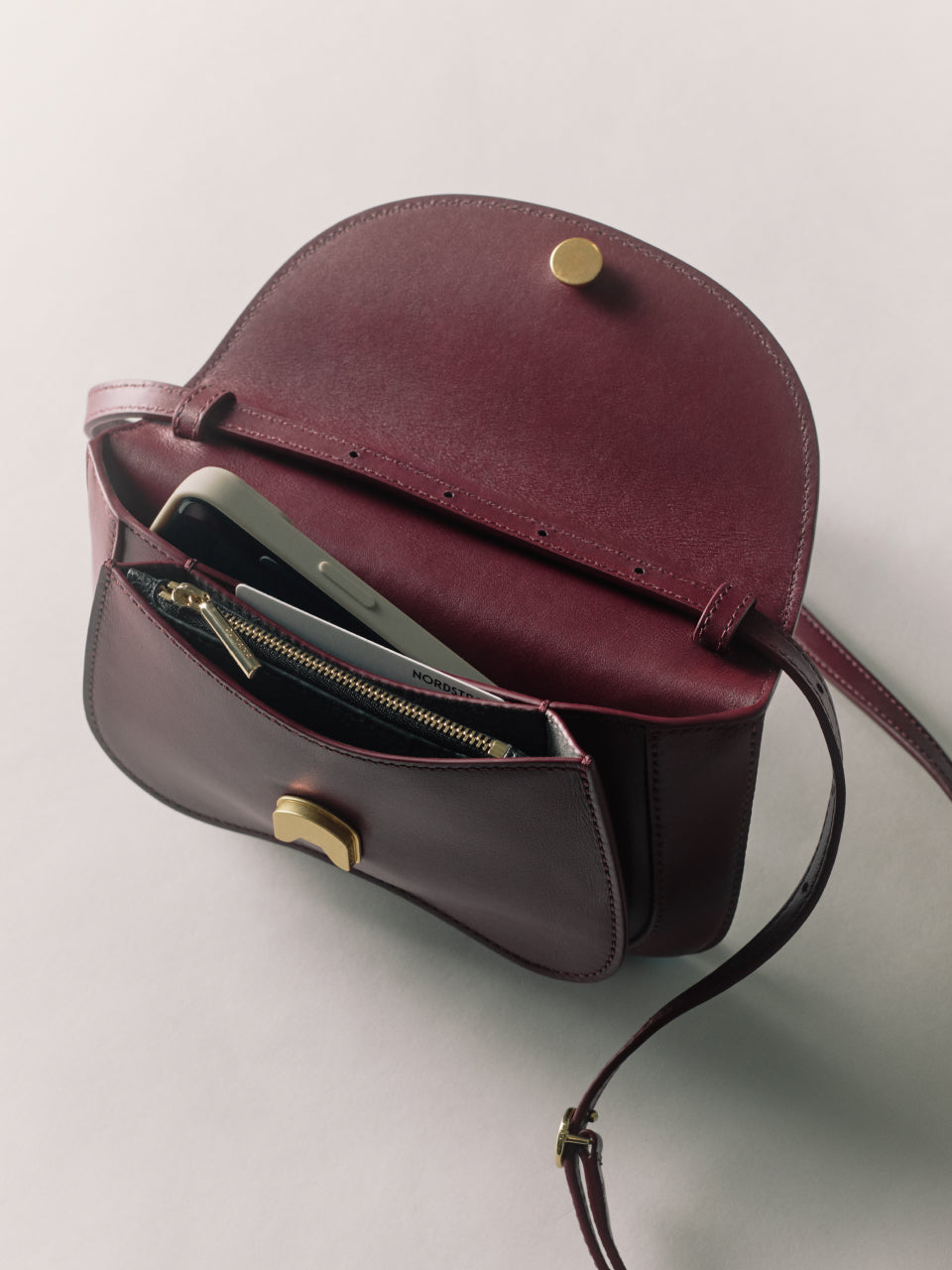 Open handbag with phone and wallet inside