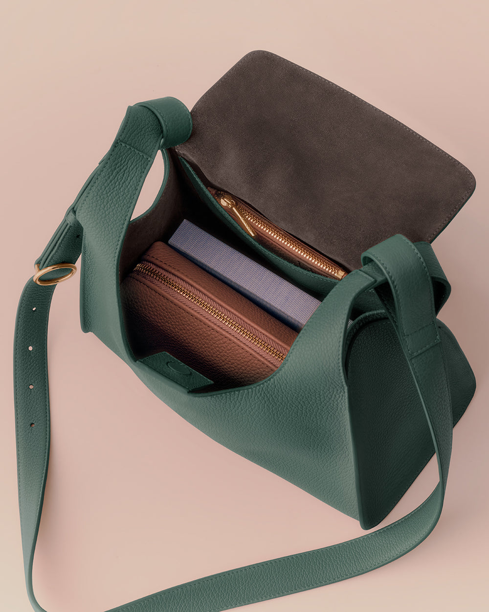 Open handbag with items inside, showing a wallet and a book.