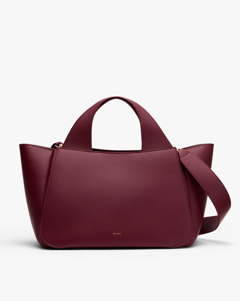 A large handbag with short handles and a long wide strap.