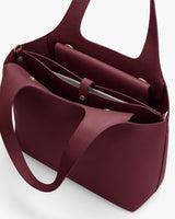 Open handbag with compartments and a shoulder strap.