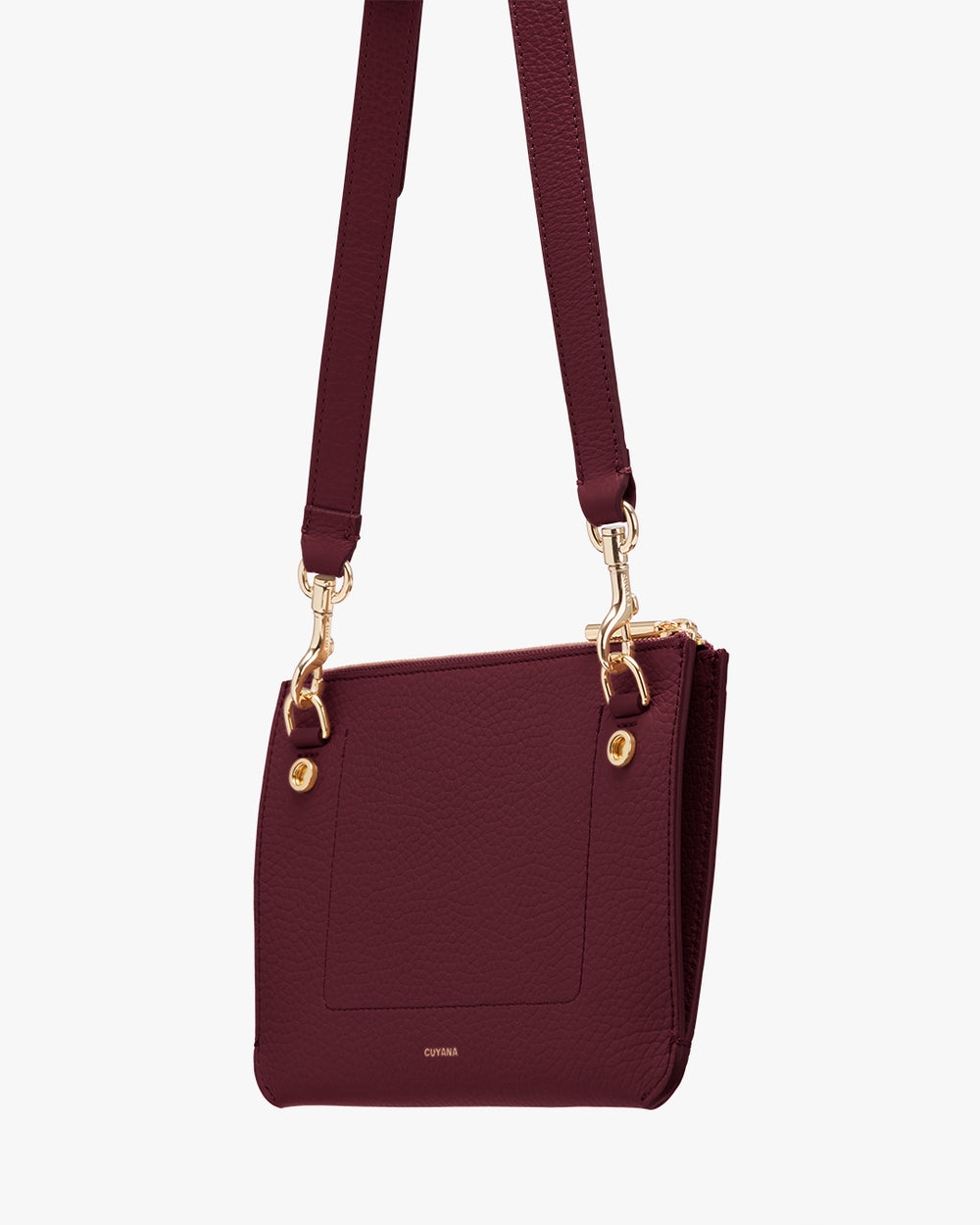 A shoulder bag with a front pocket and gold hardware on the strap attachments.