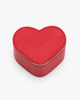 Heart-shaped leather box on a plain background