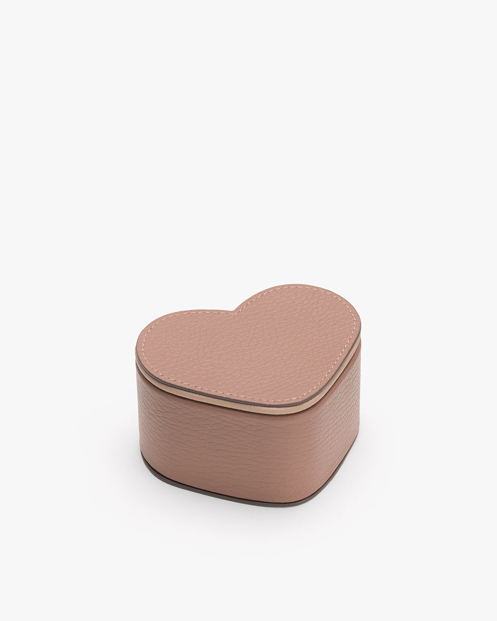 Heart-shaped box with textured surface on plain background.