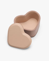 Heart-shaped container with detachable lid.