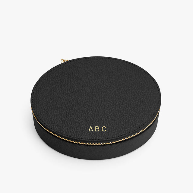 Round zippered case with initials on top.