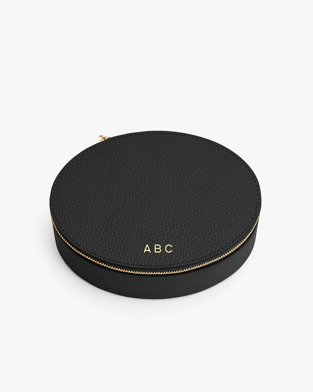 Round zippered case with initials on top.