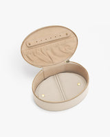 Oval jewelry case with open lid, displaying interior compartments.