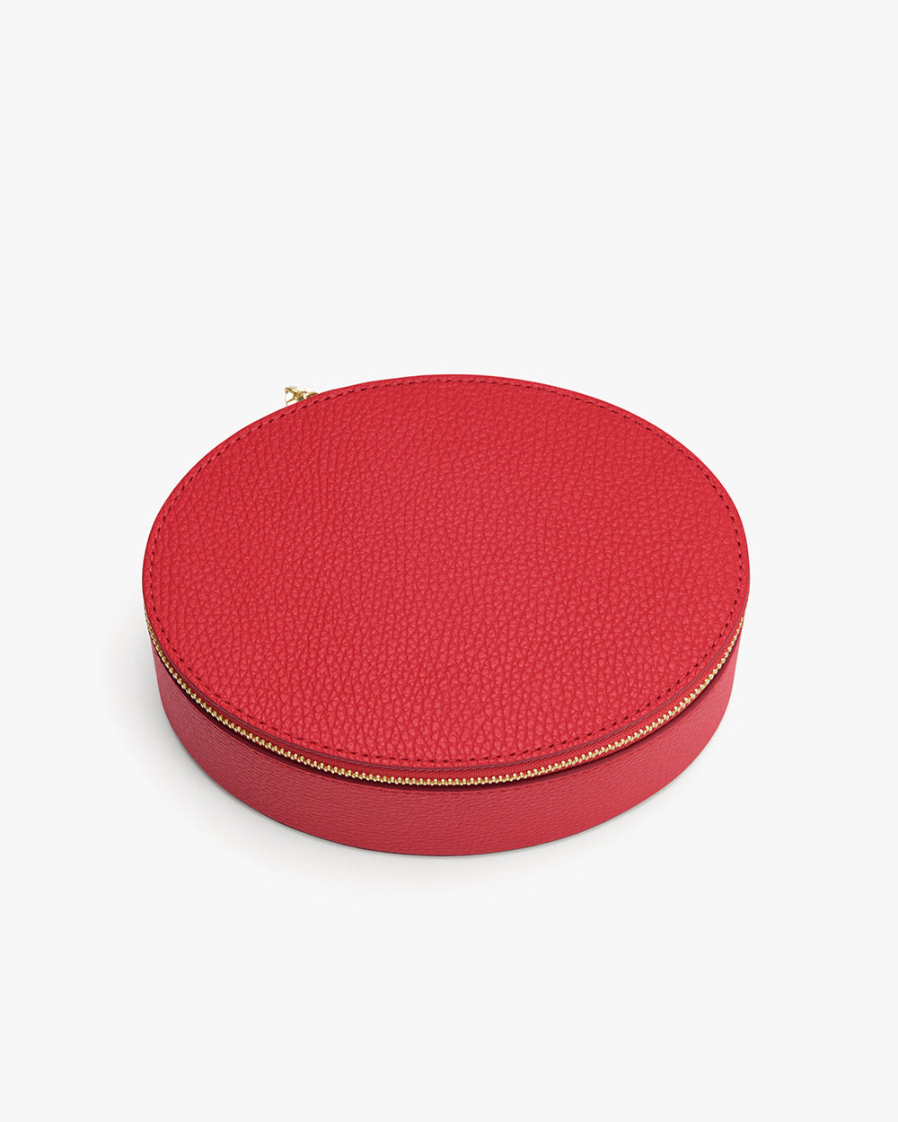 Round textured leather case with zipper.