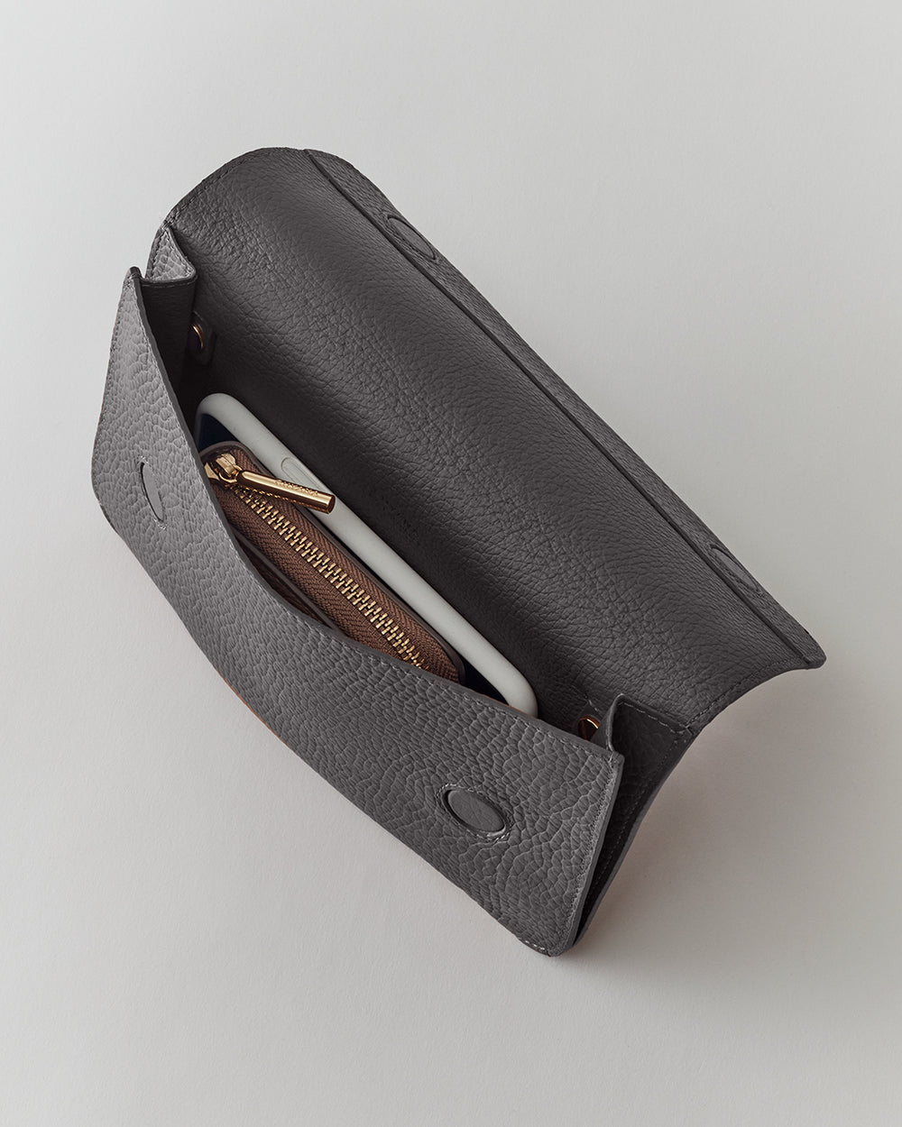 Open purse with phone and wallet inside.