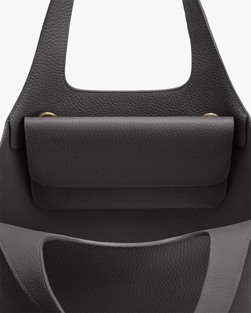 Close-up of a handbag with a front pocket and two handles.