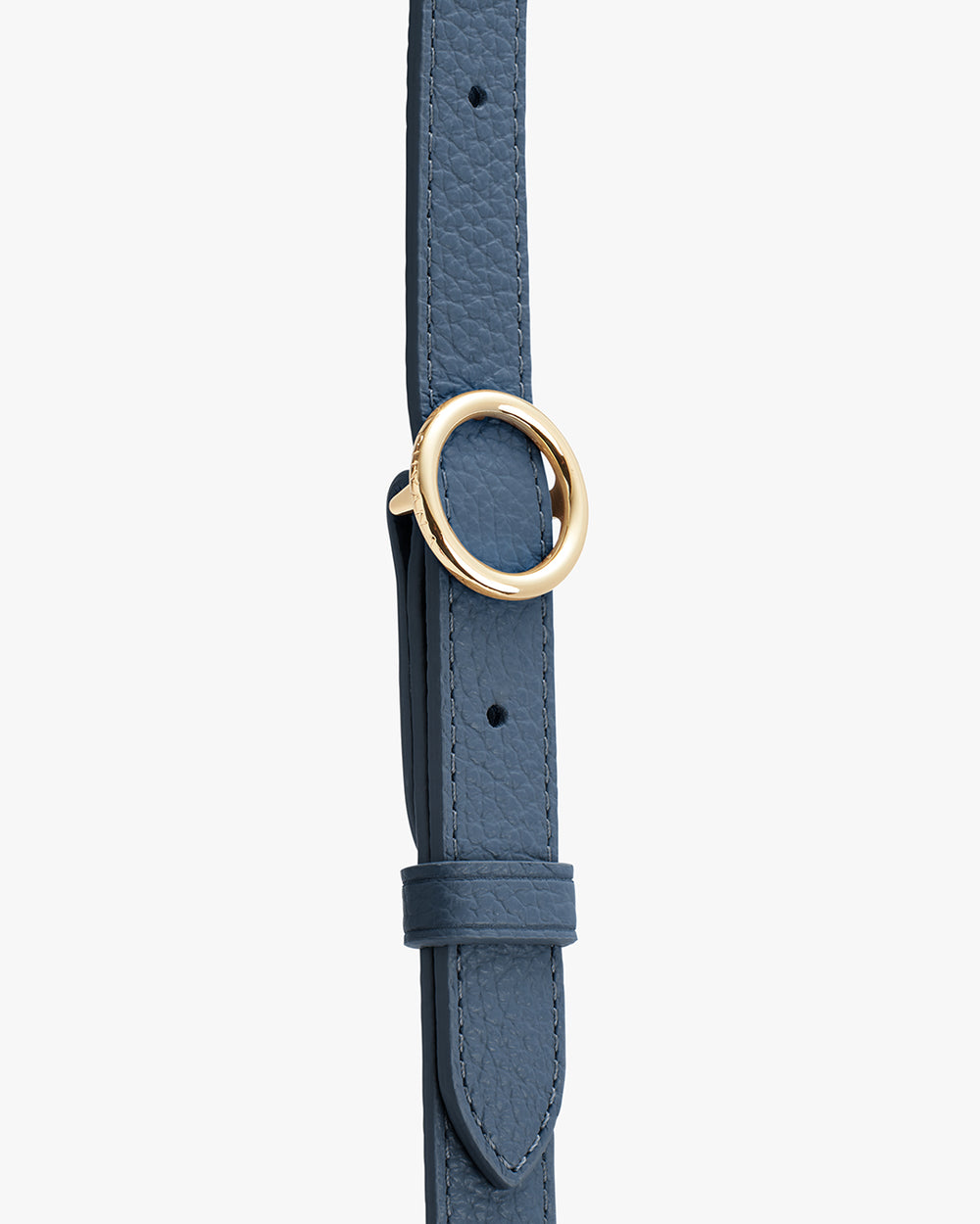 Close-up of a leather strap with a gold ring to adjust the length