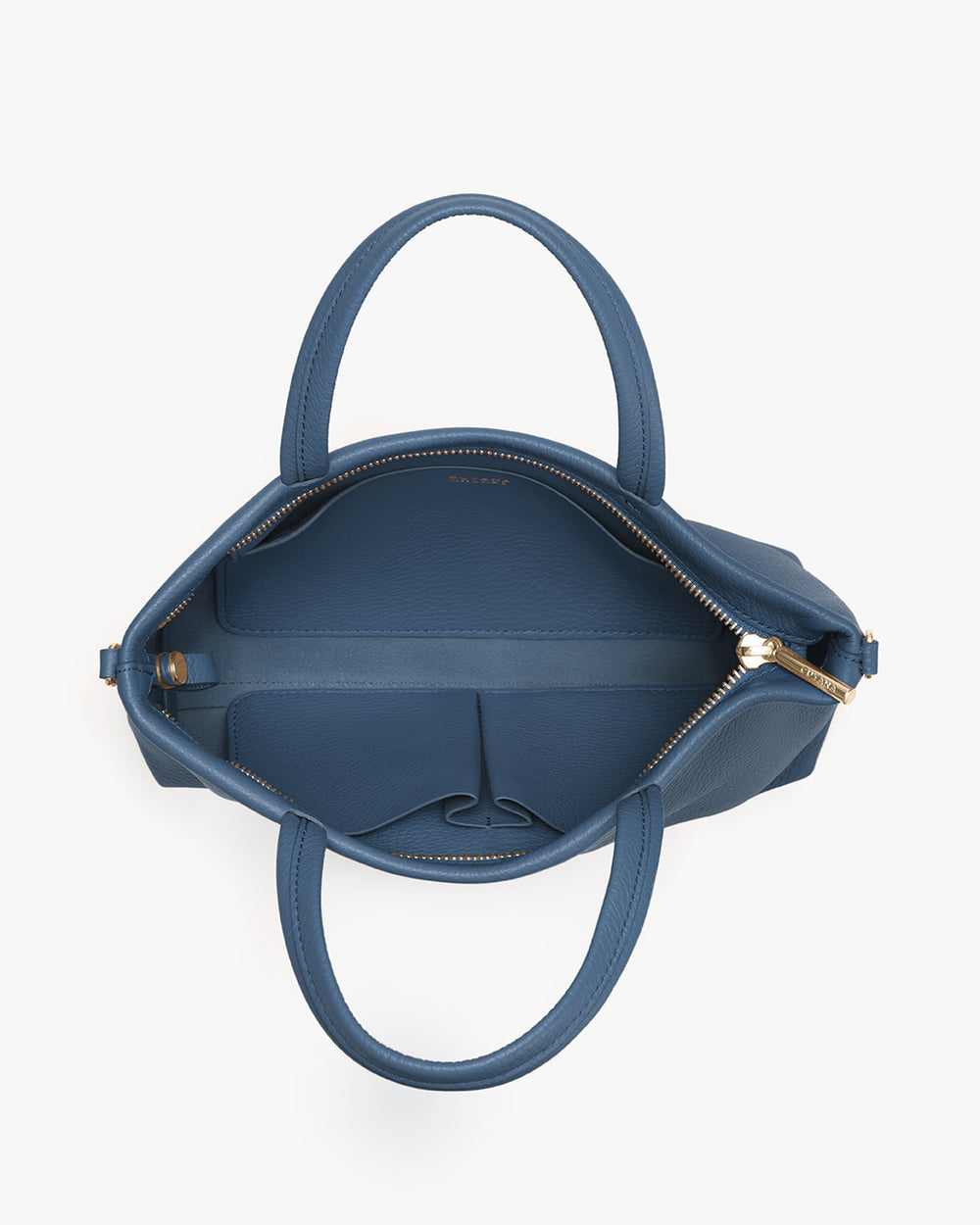 Open handbag with handles and zipper, showing interior pockets.