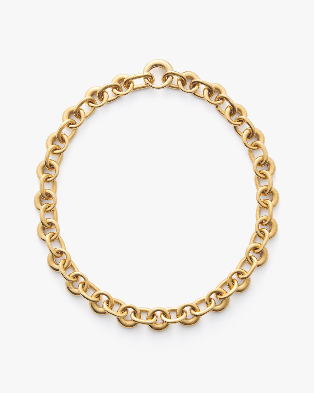 Chain necklace in a circular design placed on a plain background