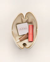 Makeup items in a zippered pouch.