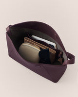 Open handbag with small pouches and sunglasses inside