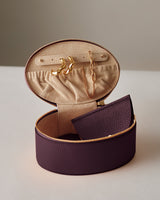 Open jewelry case with earrings and a necklace inside