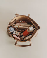 Top view of an open bag filled with baby items and toys.