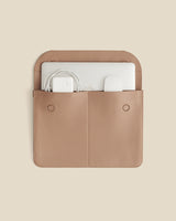 Laptop sleeve with two pockets holding a laptop and cables
