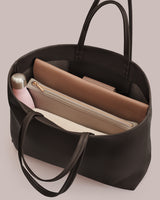 Open tote bag with a water bottle and three pouches inside.