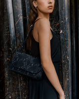 Person carrying a snakeskin-patterned shoulder bag