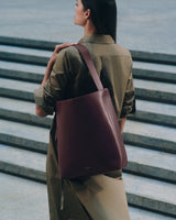 Person with shoulder bag standing on stairs